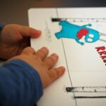 person holding blue and white paper